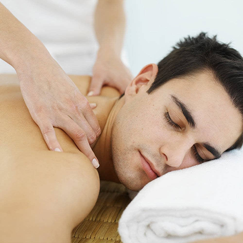 Side view of a man receiving a massage